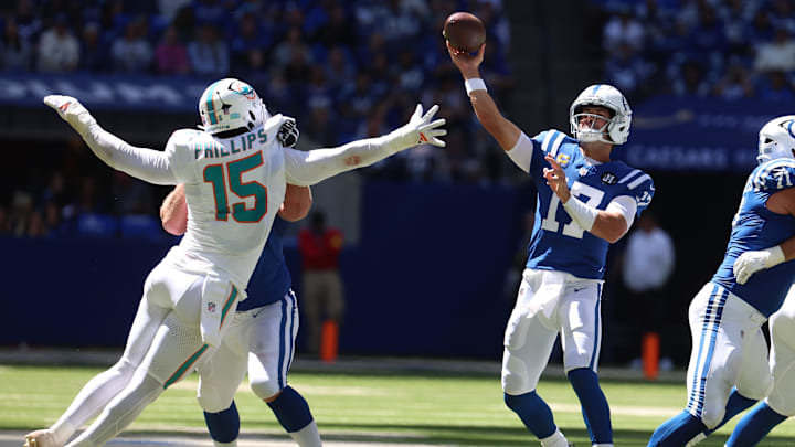 Sep 7, 2025; Indianapolis, Indiana, USA; Indianapolis Colts quarterback Daniel Jones (17) throws a touchdown against Miami Dolphins linebacker Jaelan Phillips (15) during the first half at Lucas Oil Stadium. Mandatory Credit: Trevor Ruszkowski-Imagn Images