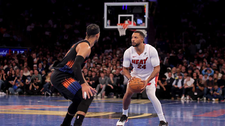 Nov 14, 2025; New York, New York, USA; Miami Heat guard Norman Powell (24) shoots a three point shot against New York Knicks guard Josh Hart (3) during the fourth quarter at Madison Square Garden. Mandatory Credit: Brad Penner-Imagn Images
