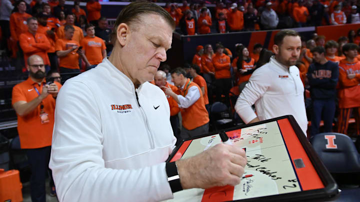Feb 4, 2026; Champaign, Illinois, USA;  Illinois Fighting Illini head coach Brad Underwood prepares his game plan before tip-off against the Northwestern Wildcats at State Farm Center. Mandatory Credit: Ron Johnson-Imagn Images