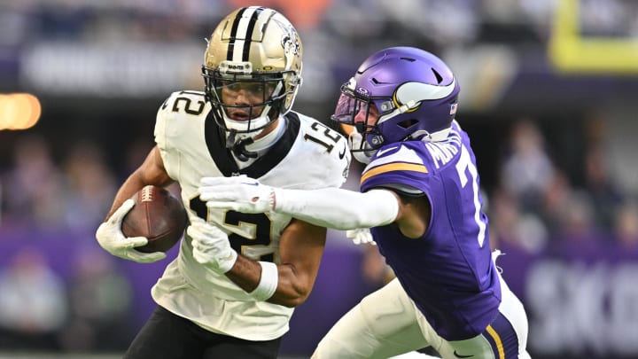 Nov 12, 2023; Minneapolis, Minnesota, USA; New Orleans Saints wide receiver Chris Olave (12) gets yards after catch as Minnesota Vikings cornerback Byron Murphy Jr. (7) pursues during the fourth quarter at U.S. Bank Stadium. Mandatory Credit: Jeffrey Becker-USA TODAY Sports