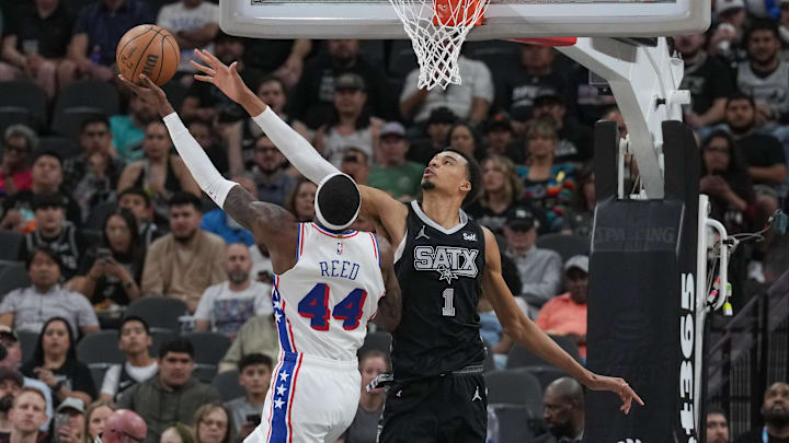 Apr 7, 2024; San Antonio, Texas, USA;  Philadelphia 76ers forward Paul Reed (44) goes up against San Antonio Spurs center Victor Wembanyama (1) in the first half at Frost Bank Center. Mandatory Credit: Daniel Dunn-Imagn Images