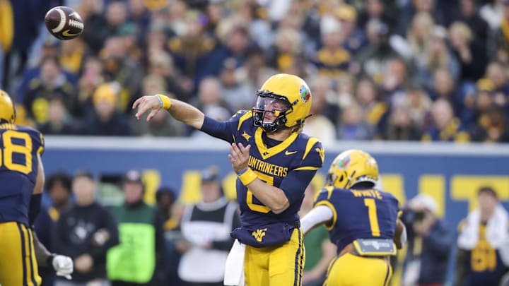 Nov 16, 2024; Morgantown, West Virginia, USA; West Virginia Mountaineers quarterback Garrett Greene (6) throws a pass during the first quarter against the Baylor Bears at Mountaineer Field at Milan Puskar Stadium. Mandatory Credit: Ben Queen-Imagn Images