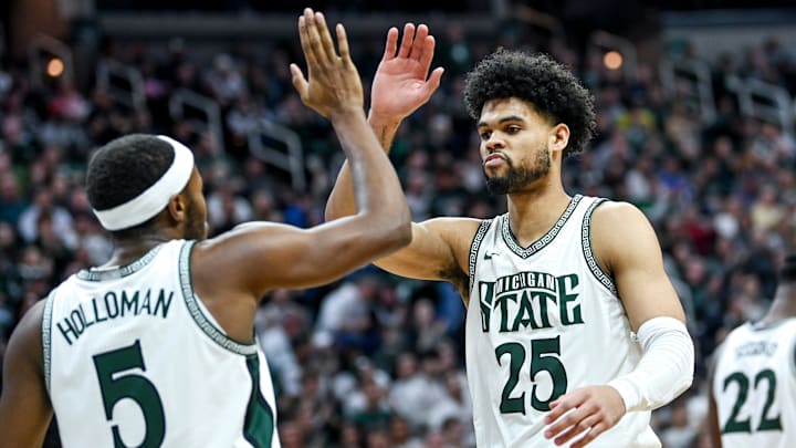 Michigan State's Tre Holloman, left, celebrates his score with Malik Hall during the second half in