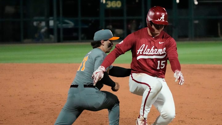 Mar 20, 2025; Tuscaloosa AL, USA; Alabama outfielder Coleman Mizell (15) barely gets back safely as Tennessee infielder Andrew Fischer (11) takes a pickoff throw from Tennessee pitcher Liam Doyle (12) at Sewell-Thomas Stadium.