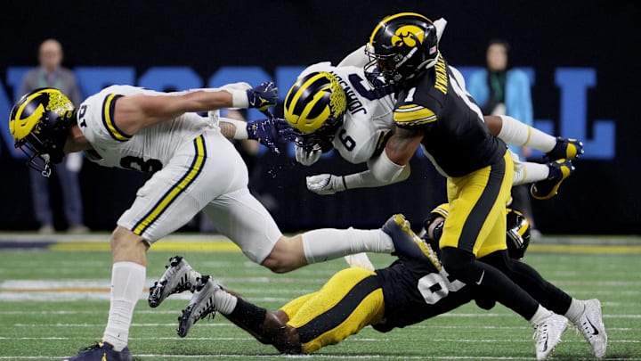 Dec 2, 2023; Indianapolis, IN, USA; Michigan Wolverines wide receiver Cornelius Johnson (6) is tackled by Iowa Hawkeyes defensive back Xavier Nwankpa (1) during the second half of the Big Ten Championship game at Lucas Oil Stadium. Mandatory Credit: Trevor Ruszkowski-USA TODAY Sports