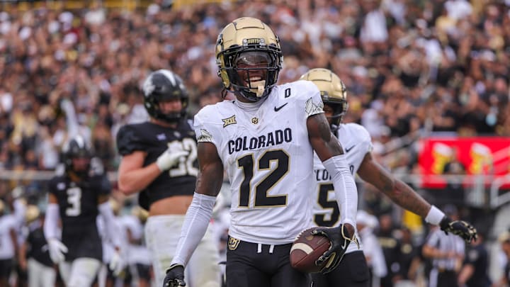 Sep 28, 2024; Orlando, Florida, USA; Colorado Buffaloes wide receiver Travis Hunter (12) scores a touchdown against the UCF Knights during the first quarter at FBC Mortgage Stadium. 