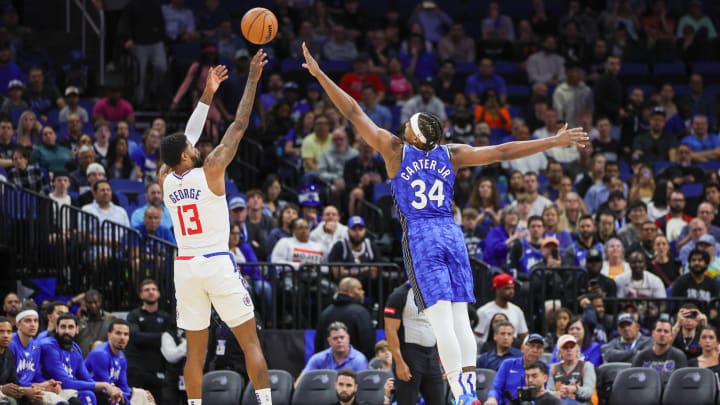 Mar 29, 2024; Orlando, Florida, USA; LA Clippers forward Paul George (13) shoots the ball over Orlando Magic center Wendell Carter Jr. (34) during the first quarter at KIA Center. Mar 29, 2024; Orlando, Florida, USA; LA Clippers forward Paul George (13) shoots the ball over Orlando Magic center Wendell Carter Jr. (34) during the first quarter at KIA Center.