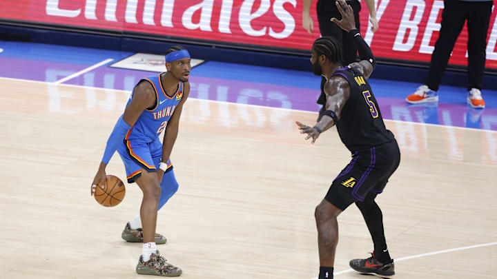 Apr 2, 2026; Oklahoma City, Oklahoma, USA; Oklahoma City Thunder guard Shai Gilgeous-Alexander (2) dribbles down the court as Los Angeles Lakers center Deandre Ayton (5) defends during the second quarter at Paycom Center. Mandatory Credit: Alonzo Adams-Imagn Images