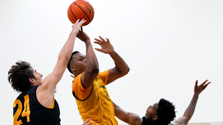 Iowa’s Cam Manyawu (4) drives to the basket as Tate Sage (24) and Tavion Banks (6) defend during practice June 19, 2025 at Carver-Hawkeye Arena in Iowa City, Iowa.