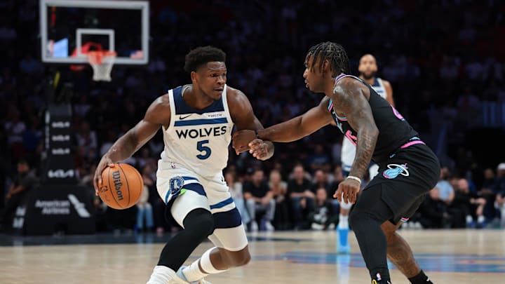 Jan 3, 2026; Miami, Florida, USA; Minnesota Timberwolves guard Anthony Edwards (5) drives to the basket against Miami Heat guard Davion Mitchell (45) during the first quarter at Kaseya Center. Mandatory Credit: Sam Navarro-Imagn Images
