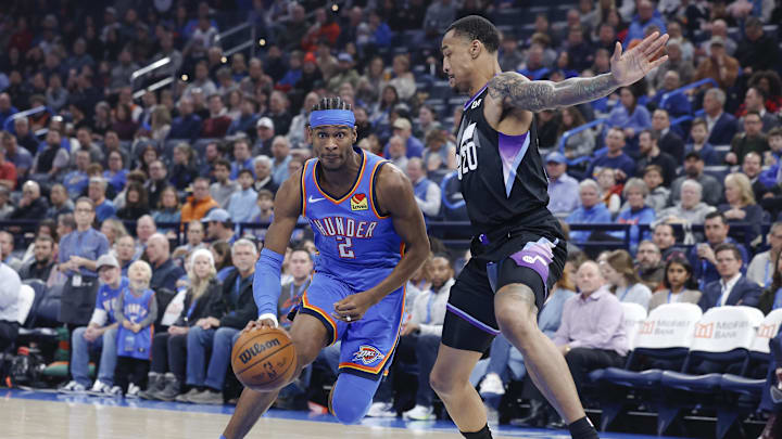Jan 22, 2025; Oklahoma City, Oklahoma, USA; Oklahoma City Thunder guard Shai Gilgeous-Alexander (2) drives to the basket against Utah Jazz forward John Collins (20) during the first quarter at Paycom Center. Mandatory Credit: Alonzo Adams-Imagn Images Jan 22, 2025; Oklahoma City, Oklahoma, USA; Oklahoma City Thunder guard Shai Gilgeous-Alexander (2) drives to the basket against Utah Jazz forward John Collins (20) during the first quarter at Paycom Center. Mandatory Credit: Alonzo Adams-Imagn Images