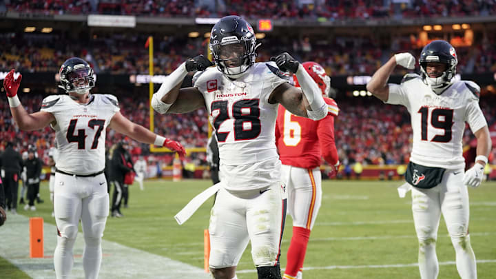 Houston Texans running back Joe Mixon (28) celebrates with fullback Andrew Beck (47) and wide receiver Xavier Hutchinson (19) after scoring a touchdown against the Kansas City Chiefs during the third quarter of a 2025 AFC divisional round game at GEHA Field at Arrowhead Stadium.