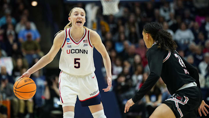 Mar 22, 2025; Storrs, Connecticut, USA; UConn Huskies guard Paige Bueckers (5) looks for an opening against the Arkansas State Red Wolves in the first half at Harry A. Gampel Pavilion. Mandatory Credit: David Butler II-Imagn Images
