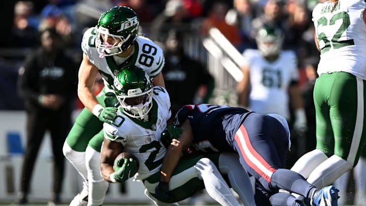 Oct 27, 2024; Foxborough, Massachusetts, USA; New England Patriots linebacker Christian Elliss (53) tackles New York Jets running back Breece Hall (20) during the first half at Gillette Stadium. 