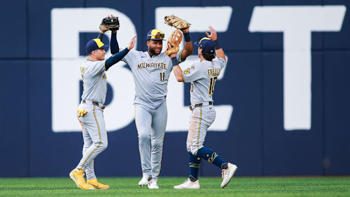 Milwaukee Brewers outfielders Isaac Collins, Jackson Chourio, and Sal Frelick celebrate a win over the Toronto Blue Jays.
