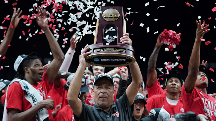Sampson holds the trophy for winning the Midwest Regional surrounded by Cougars players.