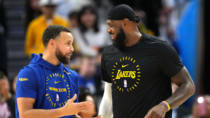 Dec 25, 2024; San Francisco, California, USA; Golden State Warriors guard Stephen Curry (left) and Los Angeles Lakers forward LeBron James (right) talk before the game at Chase Center. Mandatory Credit: Darren Yamashita-Imagn Images