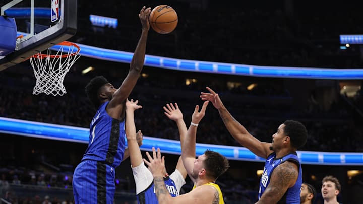 Mar 24, 2025; Orlando, Florida, USA; Orlando Magic forward Jonathan Isaac (1) blocks the shot of Los Angeles Lakers guard Luka Doncic (77) in the first quarter at Kia Center. Mandatory Credit: Nathan Ray Seebeck-Imagn Images