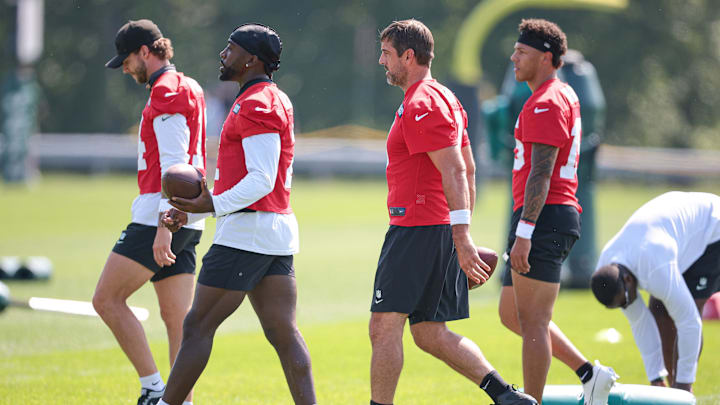 Jul 27, 2024; Florham Park, NJ, USA; New York Jets quarterback Aaron Rodgers (8) and quarterback Tyrod Taylor (2) walk across the field with teammates during training camp at Atlantic Health Jets Training Center.