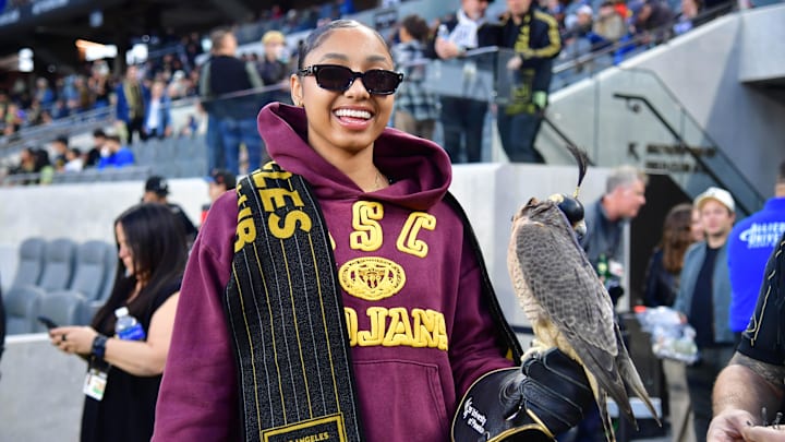 Apr 20, 2024; Los Angeles, California, USA; USC Trojans womens basketball guard JuJu Watkins smiles with the LAFC falcon before the game against the New York Red Bulls at BMO Stadium. Mandatory Credit: Gary A. Vasquez-Imagn Images