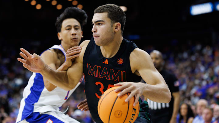 Nov 16, 2025; Jacksonville, Florida, USA; Miami Hurricanes guard Dante Allen (35) drives to the basket past Florida Gators guard Xaivian Lee (1) during the second half at VyStar Veterans Memorial Arena. Mandatory Credit: Matt Pendleton-Imagn Images