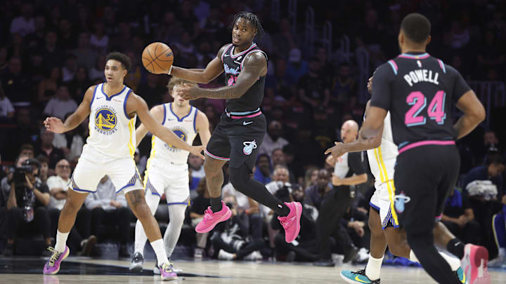 Nov 19, 2025; Miami, Florida, USA; Miami Heat guard Davion Mitchell (45) passes to guard Norman Powell (24) against the Golden State Warriors during the first half at Kaseya Center. Mandatory Credit: Rhona Wise-Imagn Images