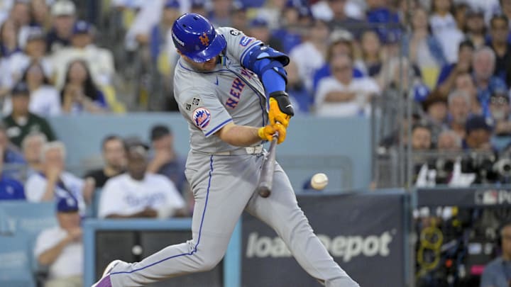 Oct 20, 2024; Los Angeles, California, USA; New York Mets first baseman Pete Alonso (20) hits a single in the third inning against the Los Angeles Dodgers during game six of the NLCS for the 2024 MLB playoffs at Dodger Stadium.
