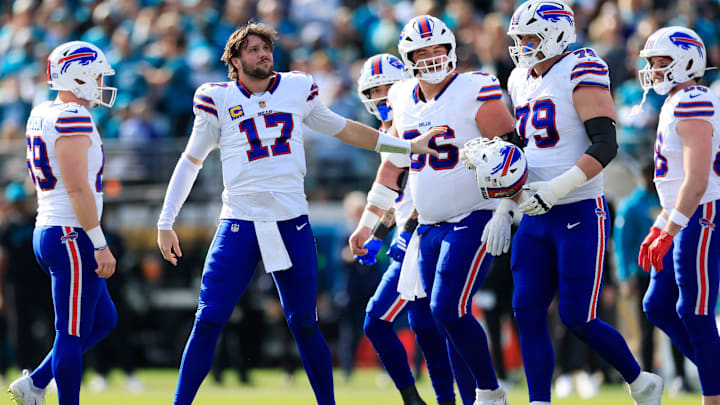 Buffalo Bills quarterback Josh Allen (17) collects his helmet from offensive tackle Spencer Brown (79) during the first quarter of an NFL football AFC Wild Card playoff matchup, Sunday, Jan. 11, 2026, in Jacksonville, Fla.