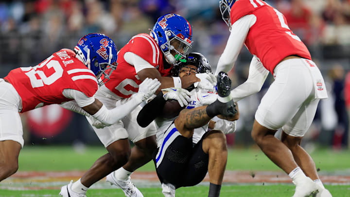 Mississippi Rebels cornerback Chris Graves Jr. (32), from left, safety Trey Washington (25), and safety John Saunders Jr. (5) work to tackle Duke Blue Devils wide receiver Eli Pancol (4) during the first quarter of the TaxSlayer Gator Bowl Thursday, Jan. 2, 2025 at EverBank Stadium in Jacksonville, Fla. [Corey Perrine/Florida Times-Union]