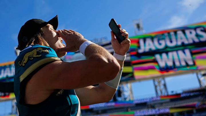 Jacksonville Jaguars quarterback Trevor Lawrence (16) makes a social media post with a hearty, “Duuuval!” while walking off the field after the game of an NFL football matchup at EverBank Stadium on Sunday, Sept. 27, 2026, in Jacksonville, Fla. The Jaguars defeated the Patriots 35-6. [Corey Perrine/Florida Times-Union]