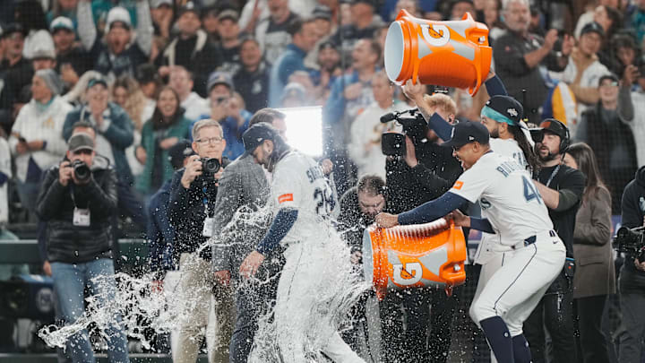 Oct 17, 2025; Seattle, Washington, USA; Seattle Mariners shortstop J.P. Crawford (3) and center fielder Julio Rodriguez (44) pour water on third baseman Eugenio Suarez (28) after game five of the ALCS round against the Toronto Blue Jays for the 2025 MLB playoffs at T-Mobile Park. Mandatory Credit: Stephen Brashear-Imagn Images Oct 17, 2025; Seattle, Washington, USA; Seattle Mariners shortstop J.P. Crawford (3) and center fielder Julio Rodriguez (44) pour water on third baseman Eugenio Suarez (28) after game five of the ALCS round against the Toronto Blue Jays for the 2025 MLB playoffs at T-Mobile Park. Mandatory Credit: Stephen Brashear-Imagn Images