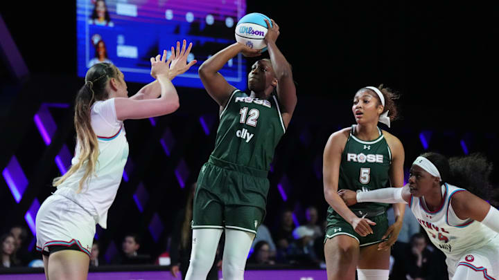 Jan 17, 2025; Miami, FL, USA; Chelsea Gray (12) shoots over Dearica Hamby (5) of the Vinyl during the second half of the Unrivaled women’s professional 3v3 basketball league at Wayfair Arena. Mandatory Credit: Jim Rassol-Imagn Images