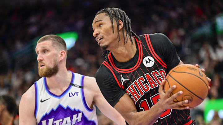 Nov 16, 2025; Salt Lake City, Utah, USA; Chicago Bulls forward Julian Phillips (15) makes a rebound against Utah Jazz guard/forward Svi Mykhailiuk (10) during the first half at Delta Center. Mandatory Credit: Peter Creveling-Imagn Images