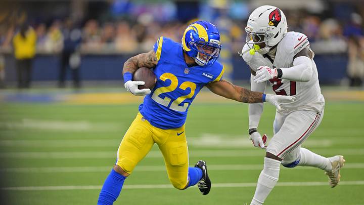 Jan 4, 2026; Inglewood, California, USA; Los Angeles Rams running back Blake Corum (22) carries the ball as Arizona Cardinals linebacker Akeem Davis-Gaither (27) defends during the second half at SoFi Stadium. Mandatory Credit: Jayne Kamin-Oncea-Imagn Images Jan 4, 2026; Inglewood, California, USA; Los Angeles Rams running back Blake Corum (22) carries the ball as Arizona Cardinals linebacker Akeem Davis-Gaither (27) defends during the second half at SoFi Stadium. Mandatory Credit: Jayne Kamin-Oncea-Imagn Images