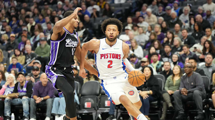 Dec 26, 2024; Sacramento, California, USA; Detroit Pistons guard Cade Cunningham (2) controls the ball against Sacramento Kings forward Keegan Murray (13) during the first quarter at Golden 1 Center. Mandatory Credit: Kelley L Cox-Imagn Images