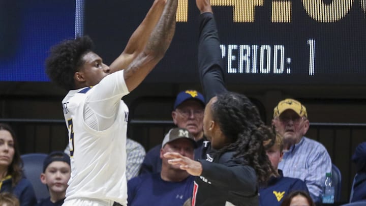 Jan 6, 2026; Morgantown, West Virginia, USA; West Virginia Mountaineers guard Honor Huff (3) shoots a three pointer over Cincinnati Bearcats guard Day Day Thomas (1) during the first half at Hope Coliseum. Mandatory Credit: Ben Queen-Imagn Images Jan 6, 2026; Morgantown, West Virginia, USA; West Virginia Mountaineers guard Honor Huff (3) shoots a three pointer over Cincinnati Bearcats guard Day Day Thomas (1) during the first half at Hope Coliseum. Mandatory Credit: Ben Queen-Imagn Images