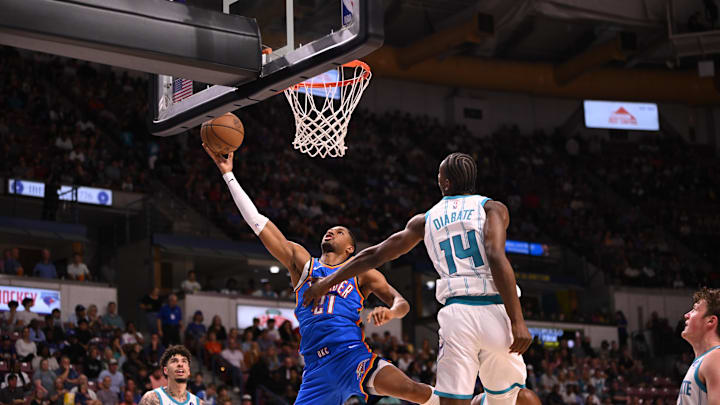 Oct 5, 2025; North Charleston, South Carolina, USA; Oklahoma City Thunder guard Aaron Wiggins (21) tosses up a shot against the Charlotte Hornets in the first quarter at North Charleston Coliseum. Mandatory Credit: Arthur Ellis-Imagn Images