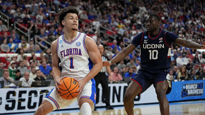 Mar 23, 2025; Raleigh, NC, USA; Florida Gators guard Walter Clayton Jr. (1) controls the ball as Connecticut Huskies guard Hassan Diarra (10) defends during the second half in the second round of the NCAA Tournament at Lenovo Center. Mandatory Credit: Bob Donnan-Imagn Images