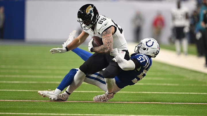 Jan 5, 2025; Indianapolis, Indiana, USA; Jacksonville Jaguars tight end Luke Farrell (89) is tackled by Indianapolis Colts linebacker Jaylon Carlies (57) during the first quarter at Lucas Oil Stadium. 