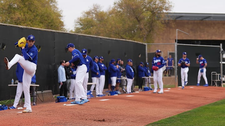Feb 12, 2025; Glendale, AZ, USA; Los Angeles Dodgers pitcher Roki Sasaki (11) throws during a Spring Training workout at Camelback Ranch. Mandatory Credit: Joe Camporeale-Imagn Images