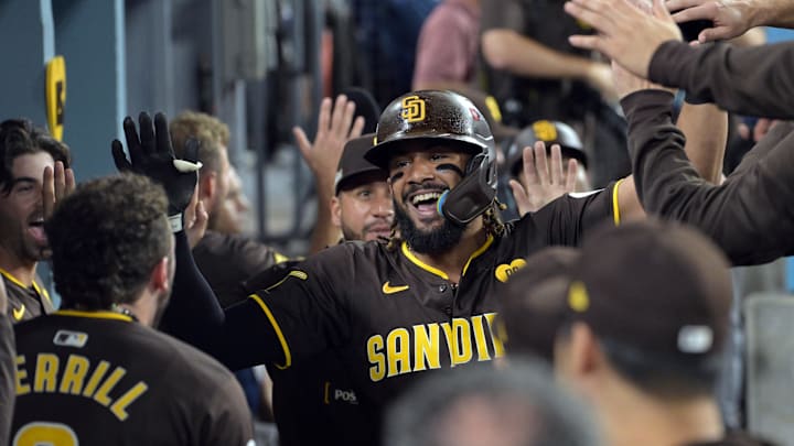 Oct 6, 2024; Los Angeles, California, USA; San Diego Padres outfielder Fernando Tatis Jr. (23) celebrates in the dugout after hitting a two run home run in the ninth inning against the Los Angeles Dodgers during game two of the NLDS for the 2024 MLB Playoffs at Dodger Stadium. Mandatory Credit: Jayne Kamin-Oncea-Imagn Images