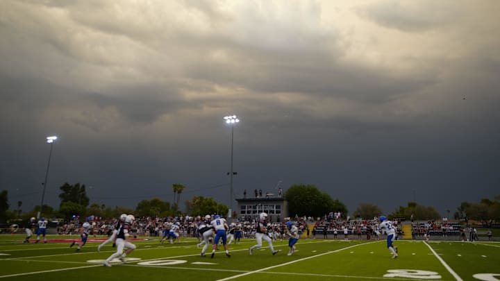 A head football coach in Arizona has been suspended for not reporting an auto accident over the summer.