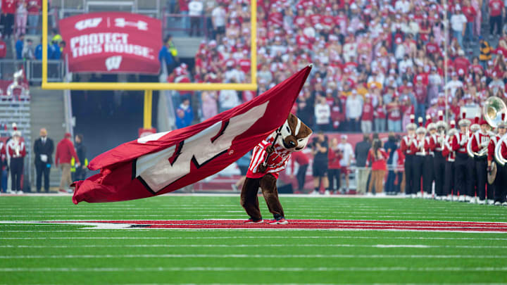 Oct 11, 2025; Madison, Wisconsin, USA; Bucky Badger waves a Wisconsin flag at mid field before a game between the Wisconsin Badgers and the Iowa Hawkeyes at Camp Randall Stadium. Mandatory Credit: Ross Harried-Imagn Images Oct 11, 2025; Madison, Wisconsin, USA; Bucky Badger waves a Wisconsin flag at mid field before a game between the Wisconsin Badgers and the Iowa Hawkeyes at Camp Randall Stadium. Mandatory Credit: Ross Harried-Imagn Images