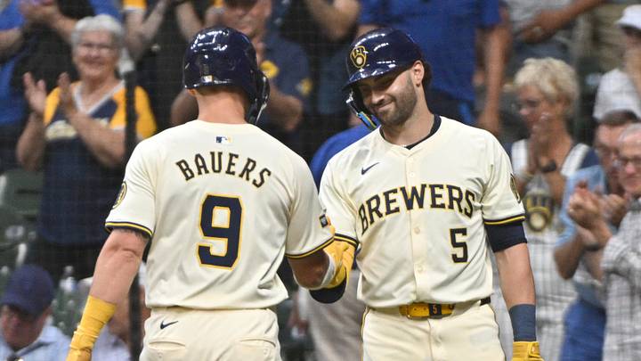 Aug 14, 2024; Milwaukee, Wisconsin, USA; Milwaukee Brewers outfielder Garrett Mitchell (5) congratulates Milwaukee Brewers first base Jake Bauers (9) after hitting a  home run against the Los Angeles Dodgers in the second inning at American Family Field. Mandatory Credit: Michael McLoone-Imagn Images