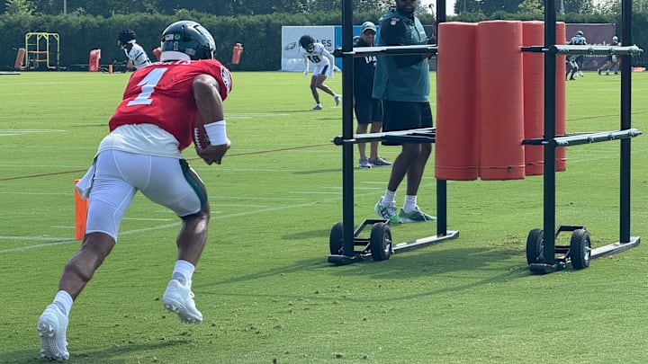 Eagles quarterback Jalen Hurts runs a ball security drill during a training camp practice. Eagles quarterback Jalen Hurts runs a ball security drill during a training camp practice.