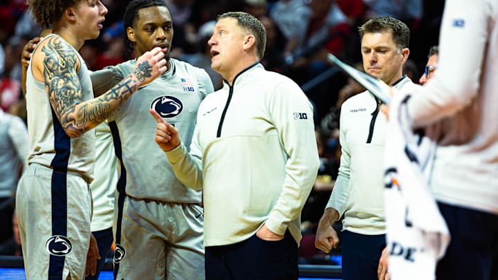 Penn State men's basketball head coach Mike Rhoades talks to Dominick Stewart (left) and Kayden Mingo during a timeout against Rutgers inside Jersey Mike's Arena in Piscataway, New Jersey on March 8, 2026.