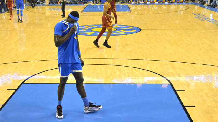 Feb 24, 2024; Los Angeles, California, USA;  UCLA Bruins forward Adem Bona (3) stands on the court as USC Trojans guard Bronny James (6) celebrates the win at Pauley Pavilion presented by Wescom. Mandatory Credit: Jayne Kamin-Oncea-USA TODAY Sports