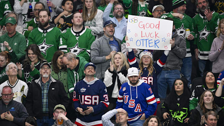 Feb 4, 2026; Dallas, Texas, USA; Hockey fans of Team USA celebrate and hold up a sign for Dallas Stars goaltender Jake Oettinger (29) during the first period against the St. Louis Blues at the American Airlines Center. Mandatory Credit: Jerome Miron-Imagn Images