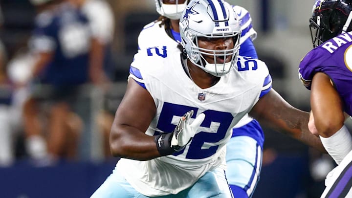 Dallas Cowboys guard Tyler Booker blocks during the first half against the Baltimore Ravens. Dallas Cowboys guard Tyler Booker blocks during the first half against the Baltimore Ravens.