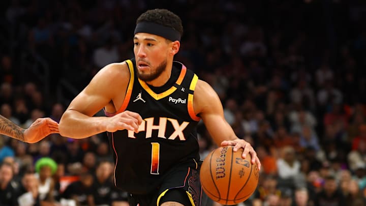 Dec 3, 2024; Phoenix, Arizona, USA; Phoenix Suns guard Devin Booker (1) against the San Antonio Spurs during an NBA Cup game at Footprint Center. Mandatory Credit: Mark J. Rebilas-Imagn Images